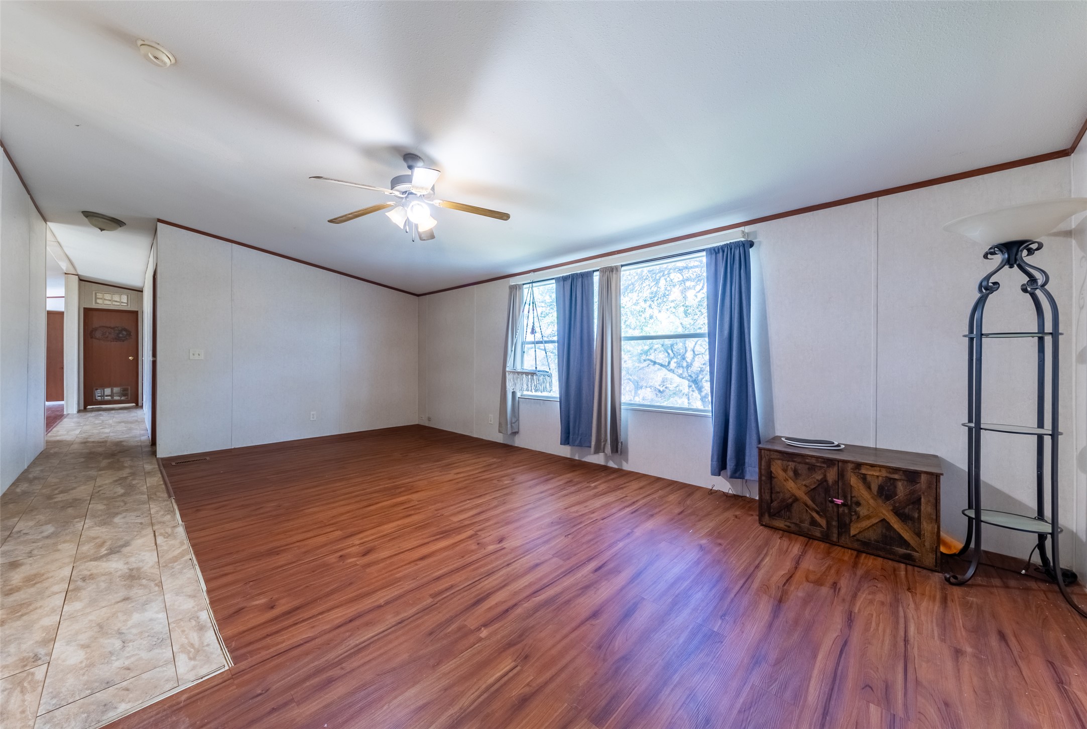 212 Fox Road San Marcos, TX 78666 - Photo 8 of 18 a view of an empty room with a window and wooden floor