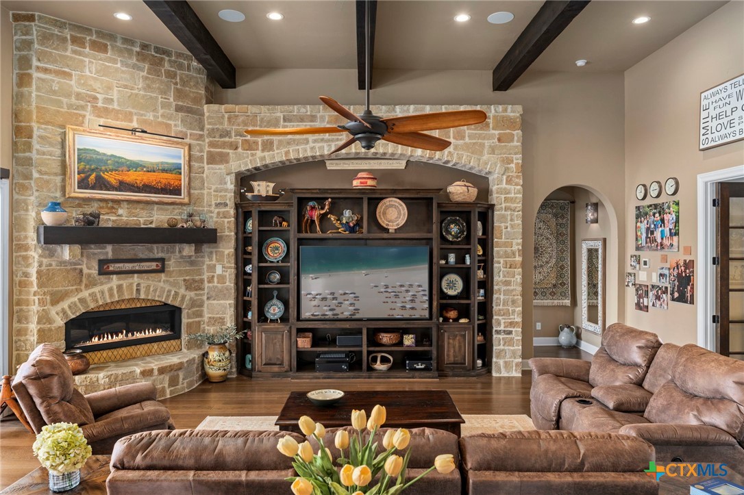 1039 Bluewater Place Spring Branch, TX 78070 - Photo 12 of 48 a living room with furniture a flat screen tv and a fireplace