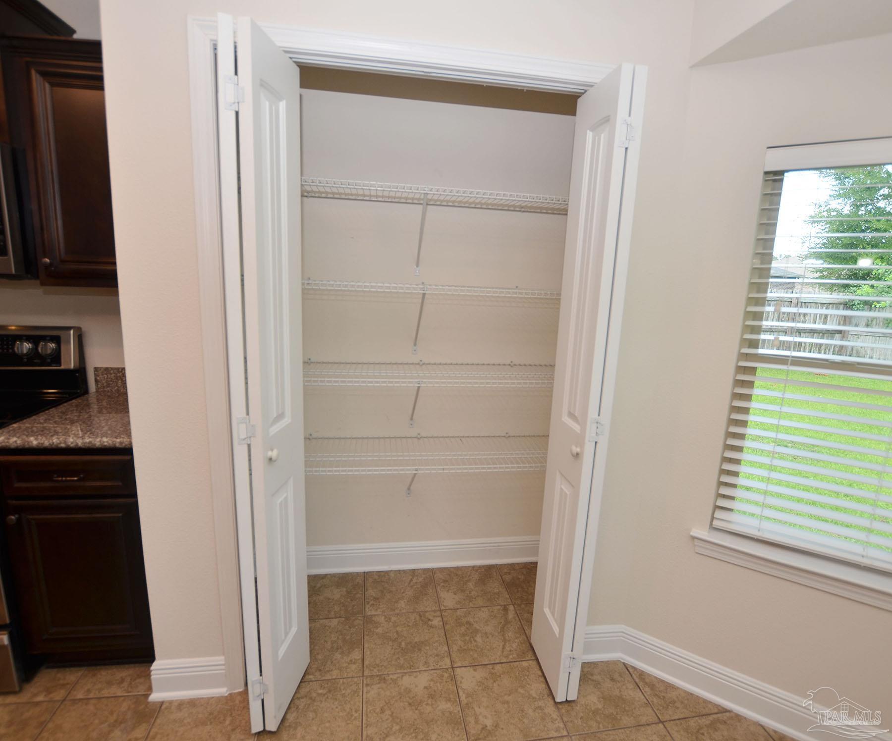 5709 Mill Stream Way Pace, FL 32571 - Photo 19 of 48 a view of an empty room with a window
