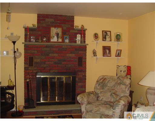 685 Magnolia Road North Brunswick, NJ 08902 - Photo 8 of 15 a living room with furniture and a fireplace