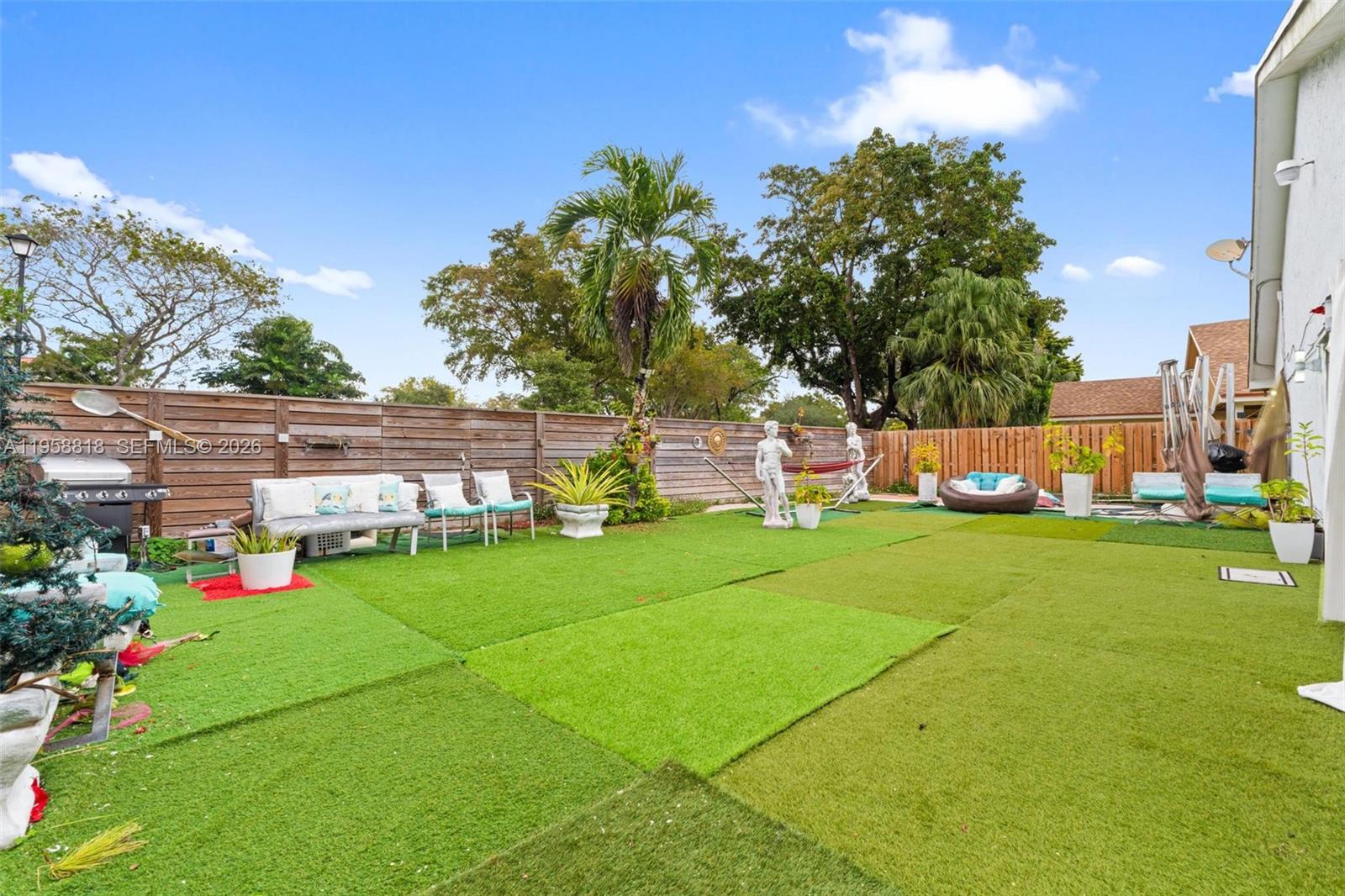 5018 Southwest 148th Place Miami, FL 33185 - Photo 11 of 14 a front view of a house with garden