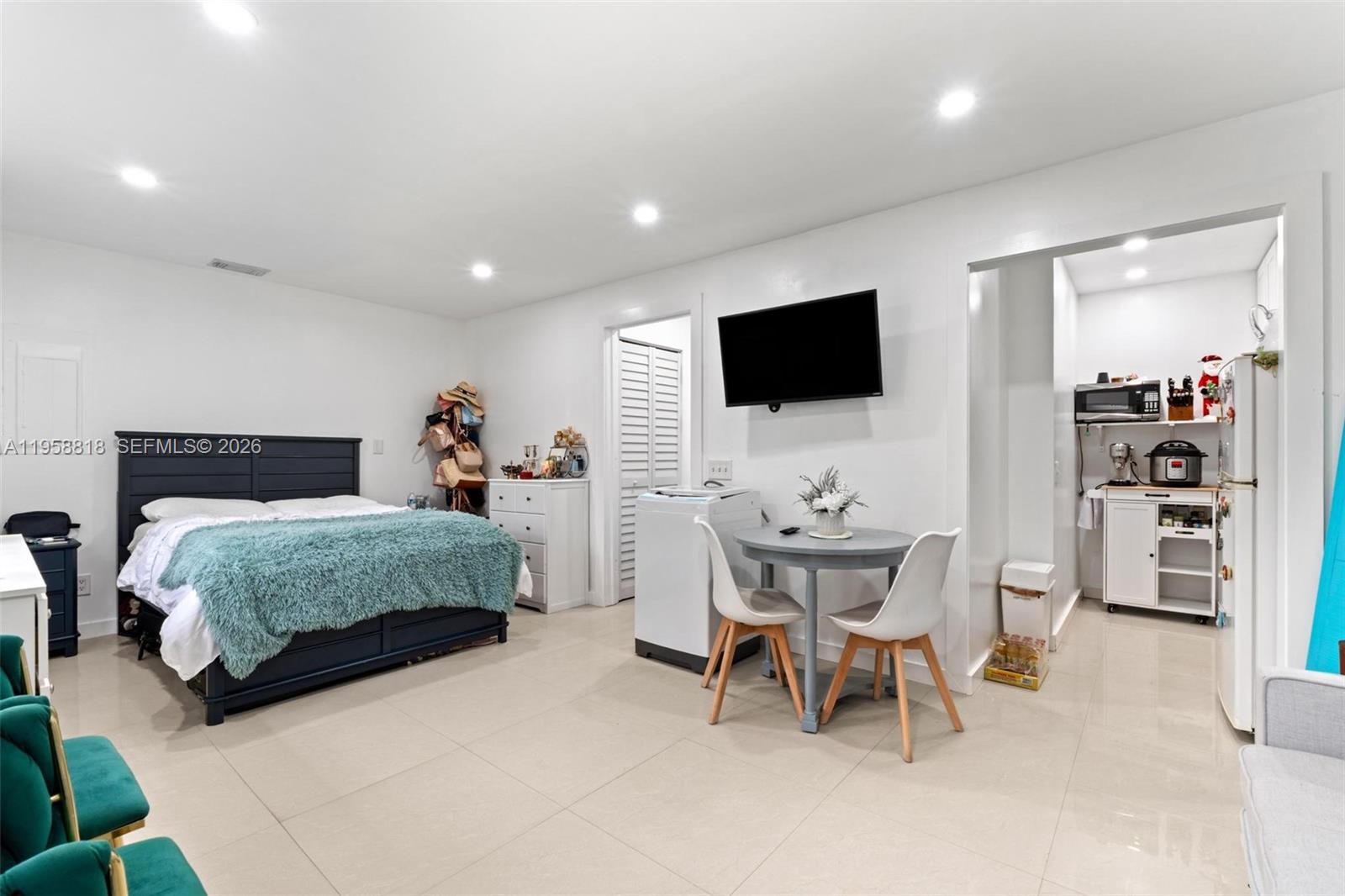 5018 Southwest 148th Place Miami, FL 33185 - Photo 12 of 14 a bedroom with a bed a chair and a flat screen tv