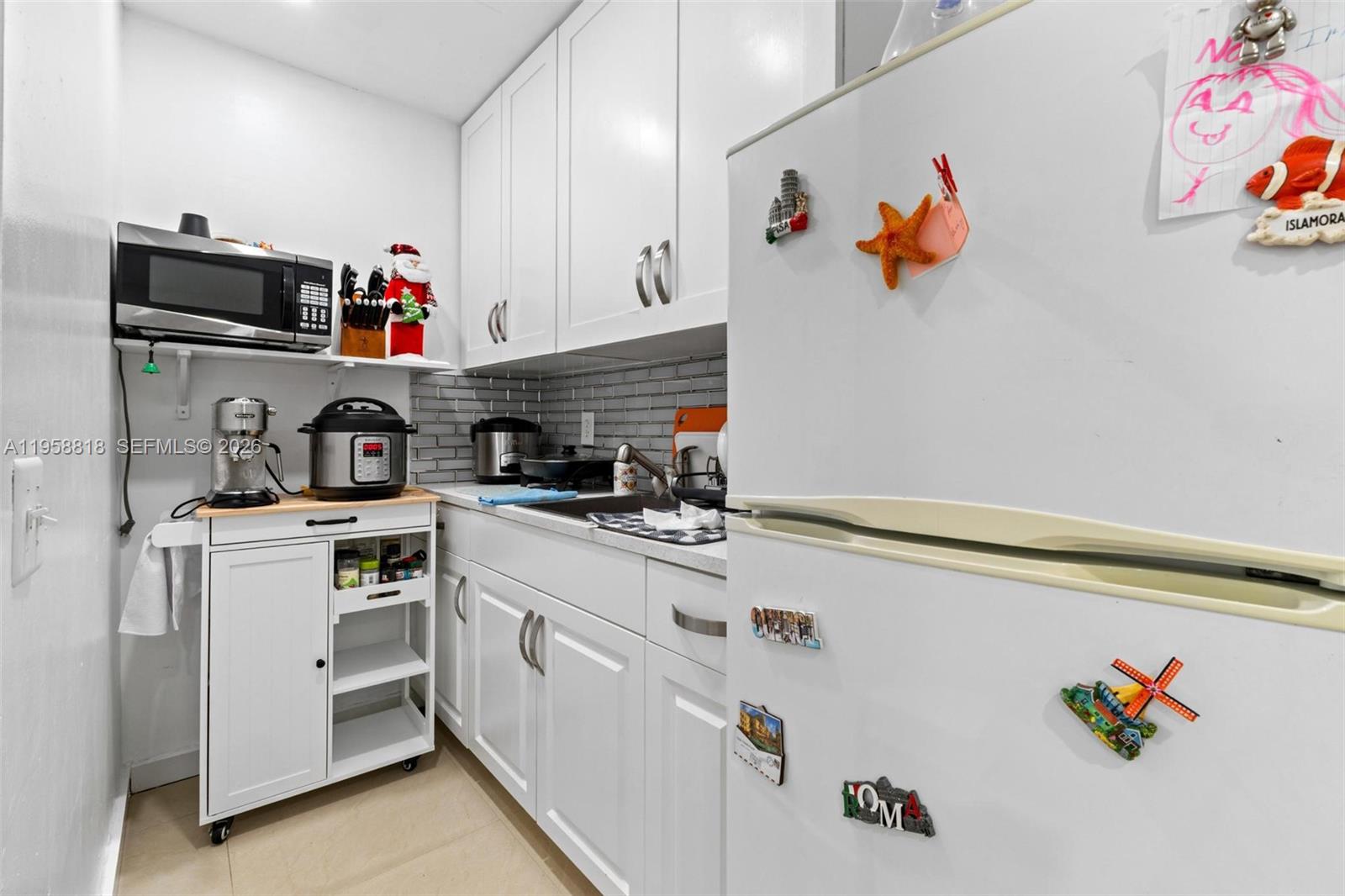 5018 Southwest 148th Place Miami, FL 33185 - Photo 13 of 14 a kitchen with a refrigerator and a stove