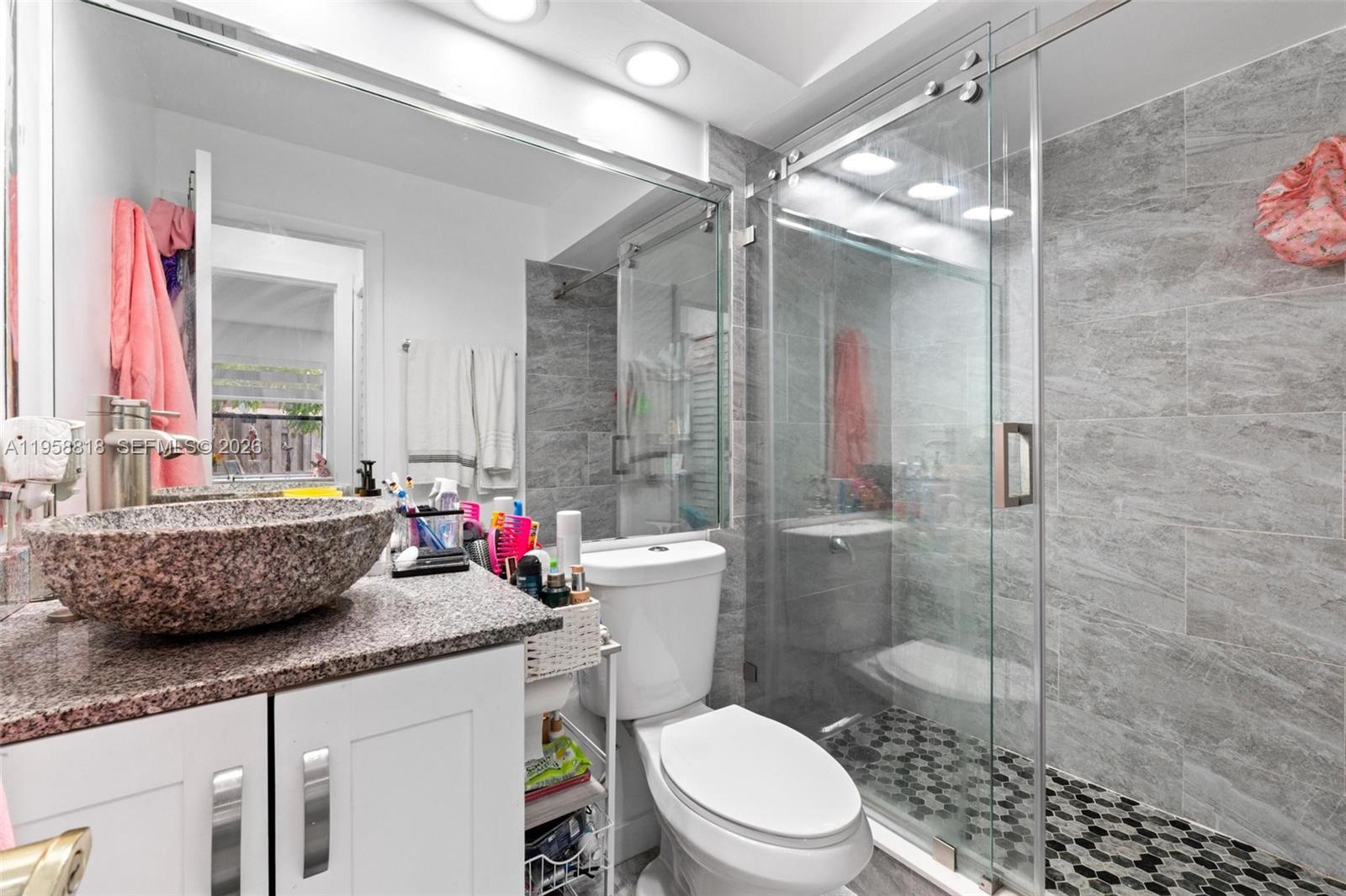 5018 Southwest 148th Place Miami, FL 33185 - Photo 14 of 14 a bathroom with a granite countertop sink mirror vanity and toilet