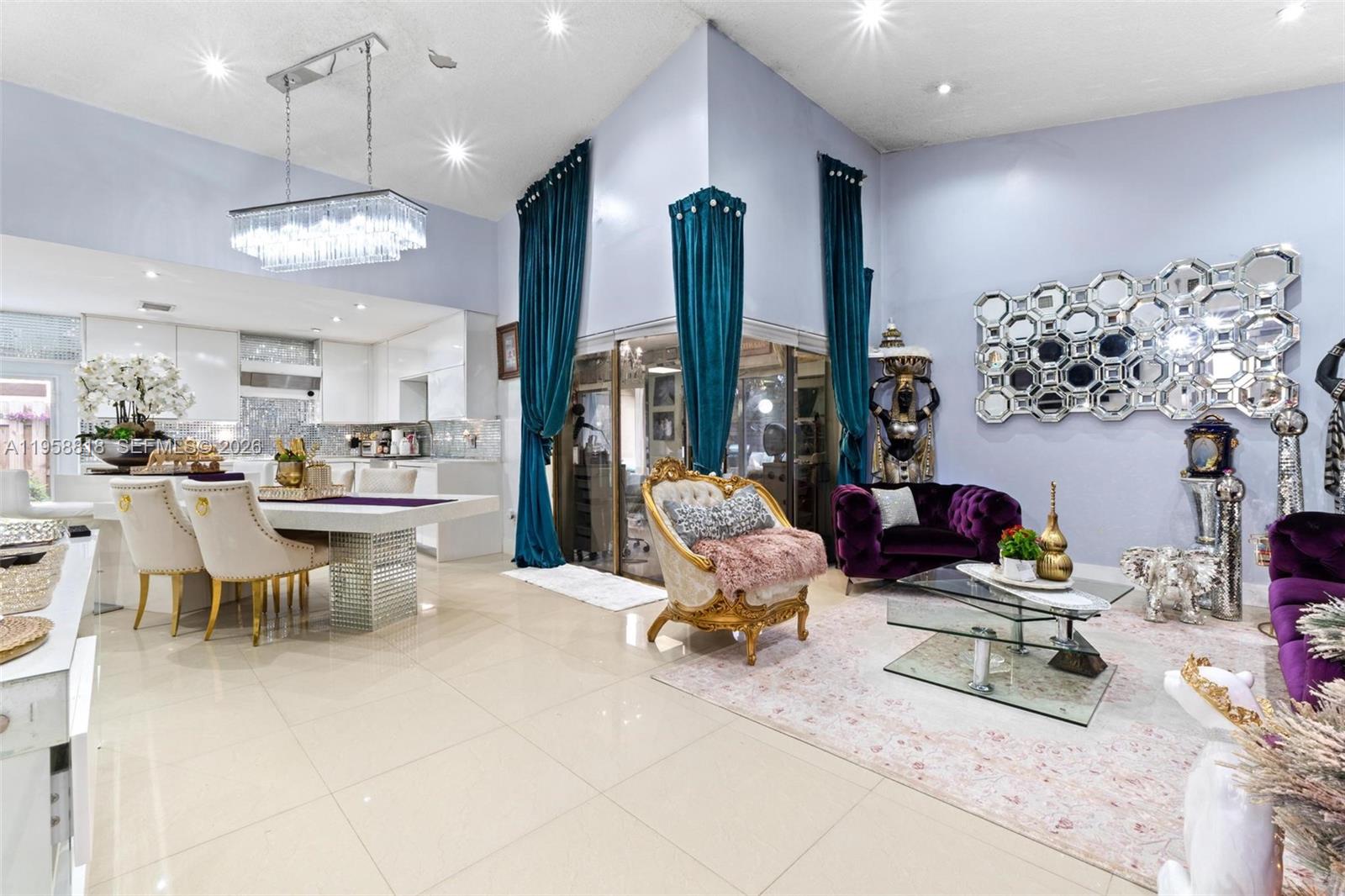 5018 Southwest 148th Place Miami, FL 33185 - Photo 2 of 14 a view of a dining room with furniture chandelier and a large window