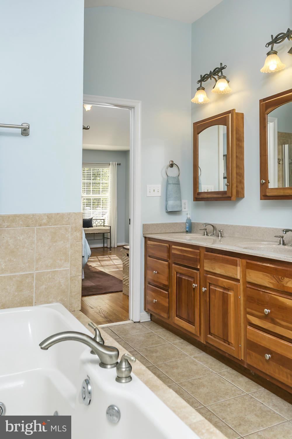 14921 Harrisville Road Mount Airy, MD 21771 - Photo 18 of 28 a spacious bathroom with a sink double vanity granite and a mirror