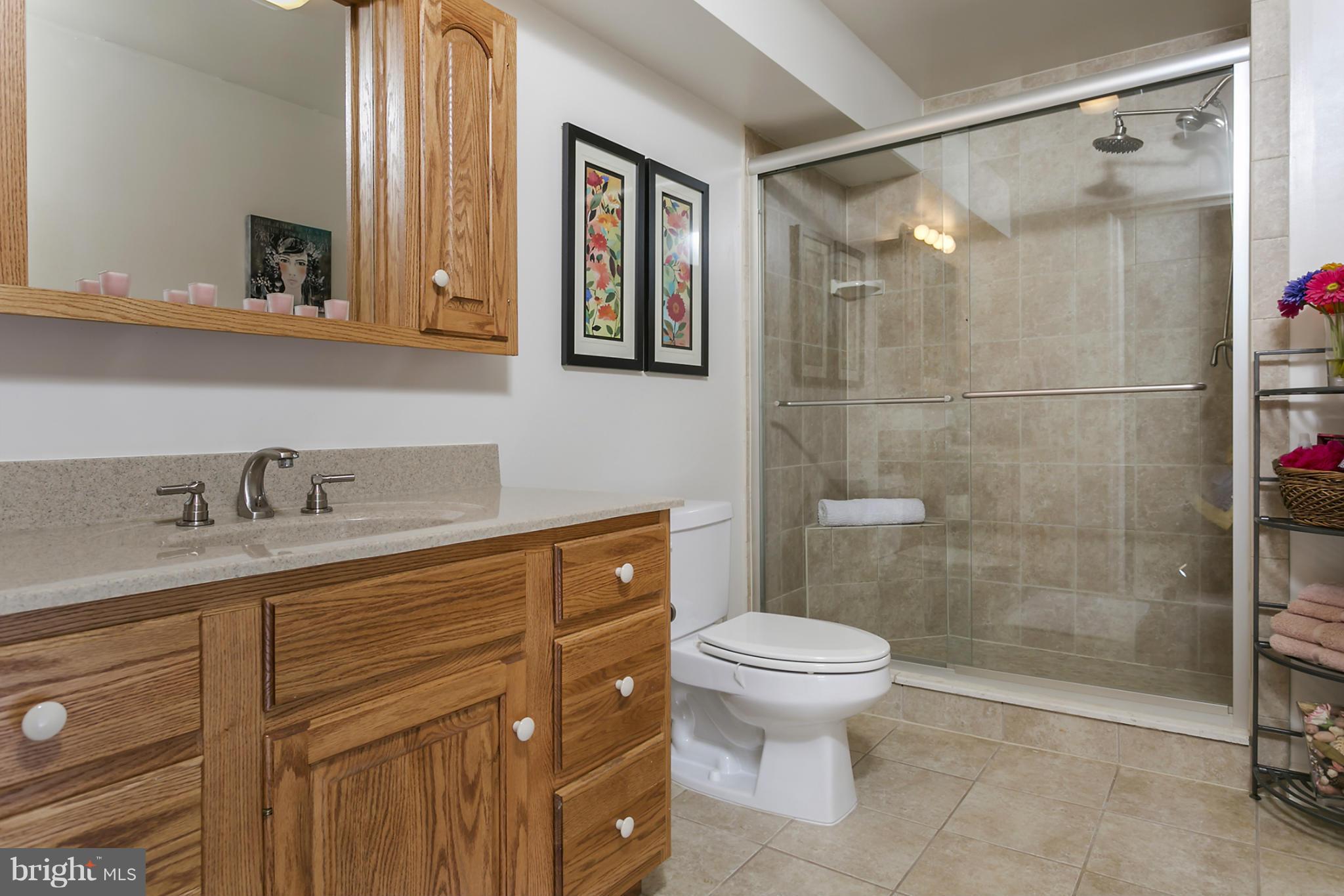 14921 Harrisville Road Mount Airy, MD 21771 - Photo 25 of 28 a bathroom with a granite countertop sink toilet and shower