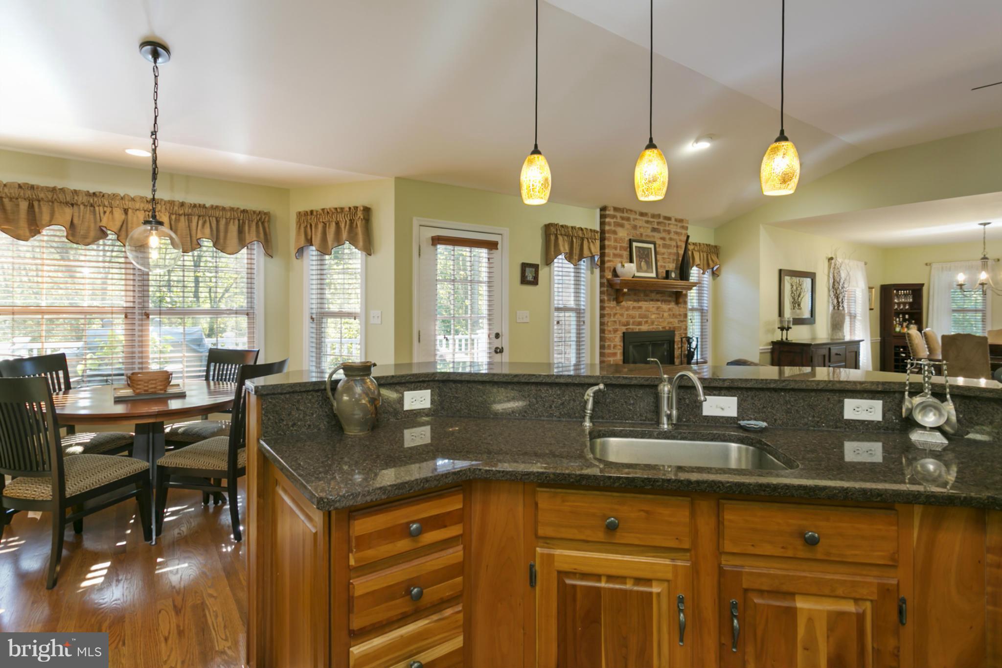 14921 Harrisville Road Mount Airy, MD 21771 - Photo 9 of 28 a kitchen with granite countertop a sink a counter space and living room view