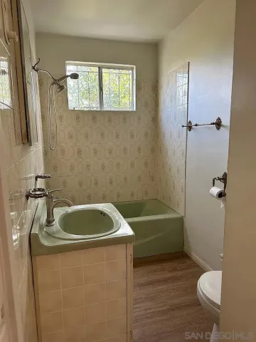 a bathroom with a sink a toilet and bathtub