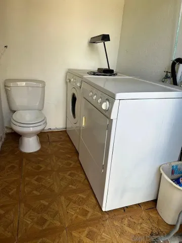 a living room with a washer and dryer