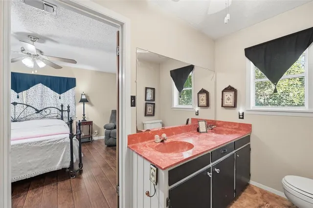 a bedroom with a large bed and a chandelier
