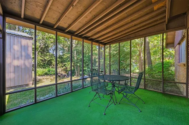 a view of porch with a table and chairs
