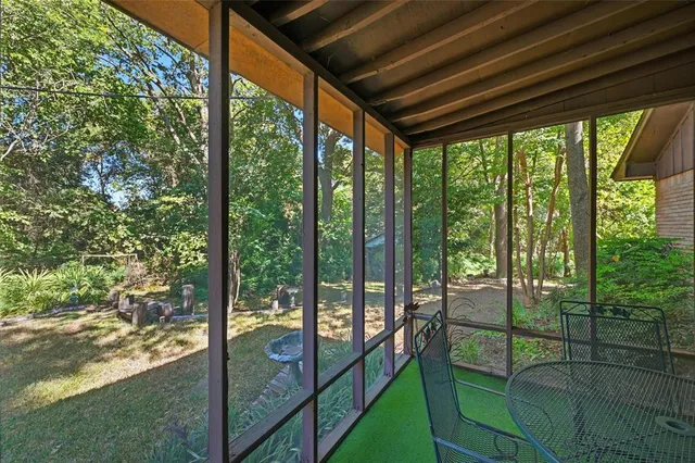 a view of backyard with wooden fence and a large tree