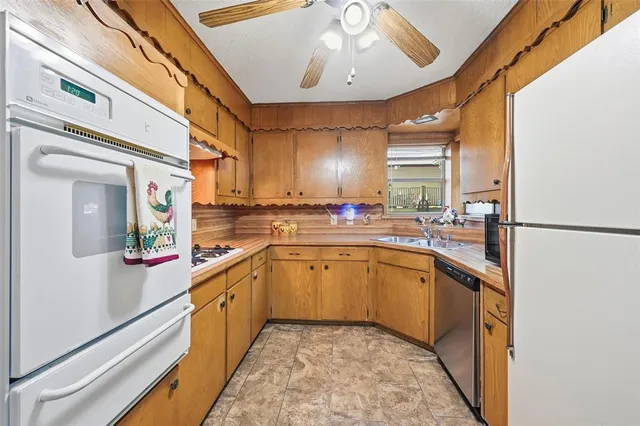 a kitchen with stainless steel appliances granite countertop cabinets and a sink