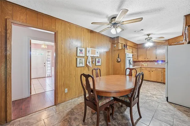 a living room with furniture fireplace and large windows