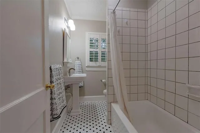 a bathroom with a bathtub and shower