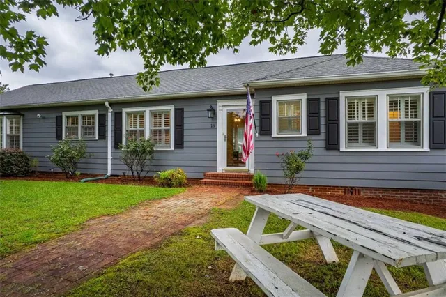 a view of a house with backyard porch and sitting area