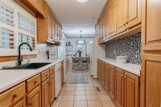 a kitchen with stainless steel appliances granite countertop a sink and cabinets