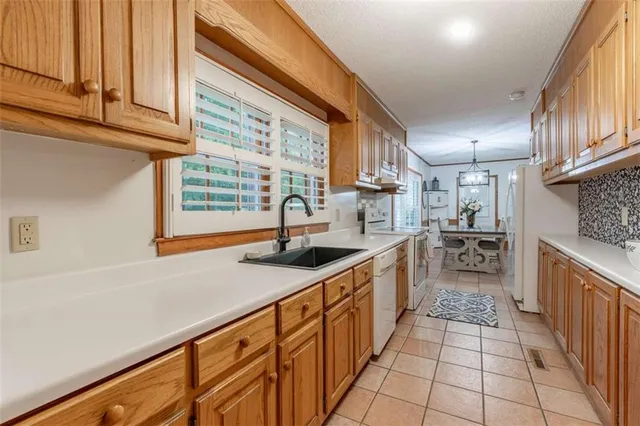 a kitchen with stainless steel appliances granite countertop a sink and a stove