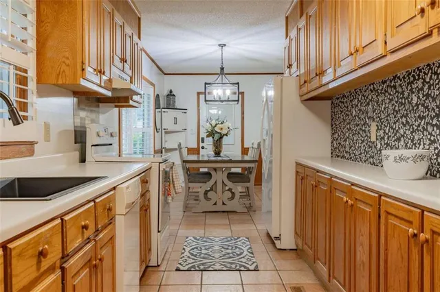 a kitchen with stainless steel appliances granite countertop a sink and cabinets
