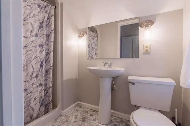 a white toilet sitting next to a bathroom sink