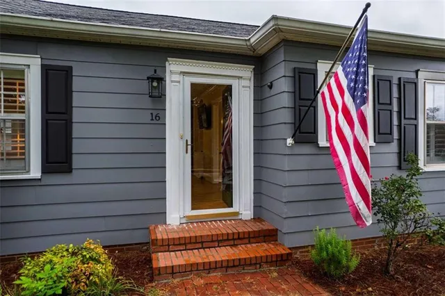a view of wooden door and a bench