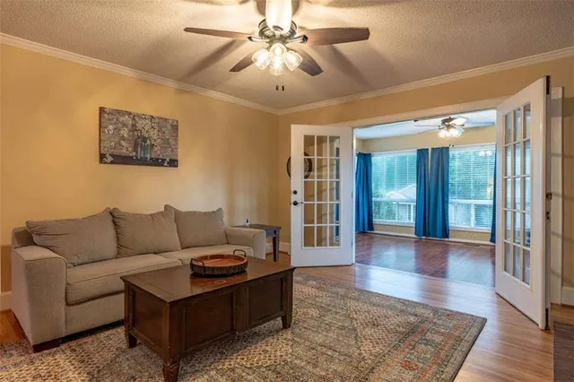 a living room with furniture and a chandelier