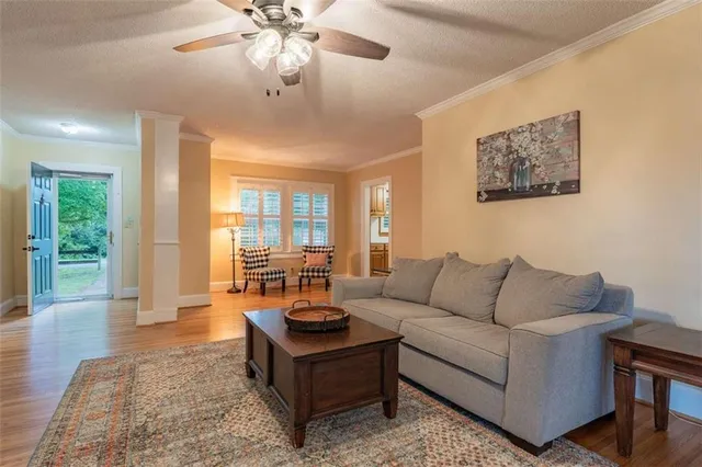 a living room with furniture and wooden floor