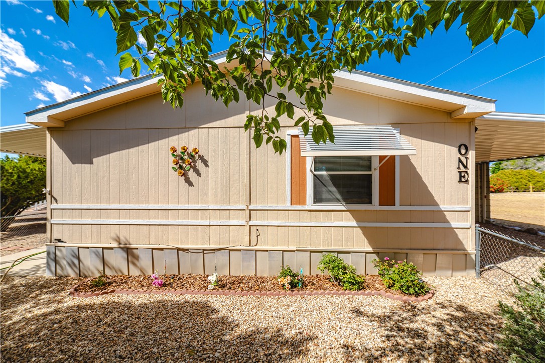 3003 Hualapai Mountain Road Kingman, AZ 86401 - Photo 41 of 49 a view of house with large windows and flower plants