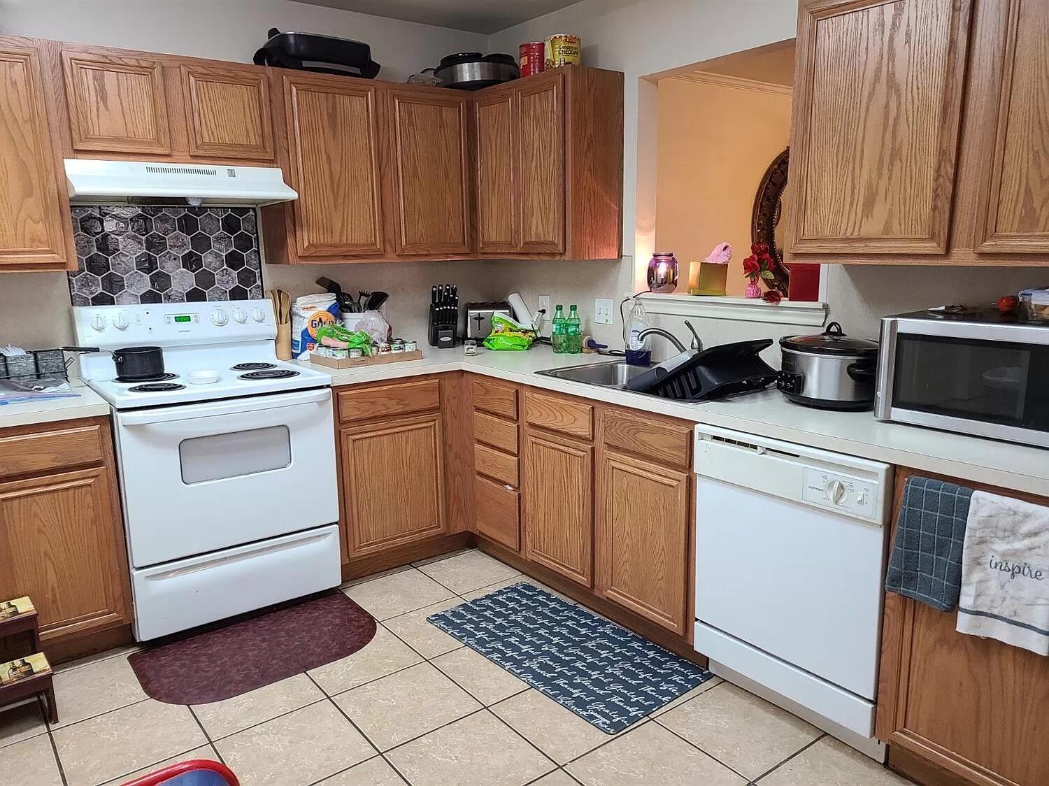 304 North Clinton Avenue, Unit A Lubbock, TX 79416 - Photo 16 of 24 a kitchen with stainless steel appliances a stove a sink and cabinets