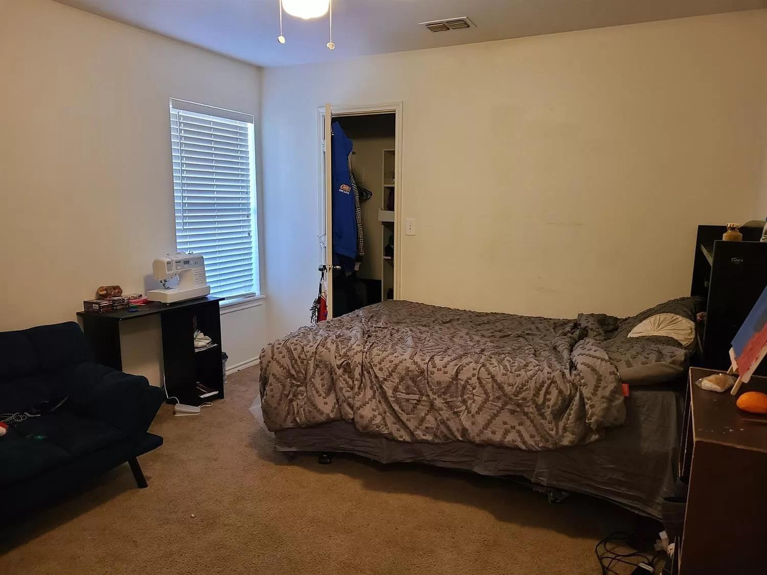 304 North Clinton Avenue, Unit A Lubbock, TX 79416 - Photo 10 of 24 a bedroom with a bed and a window