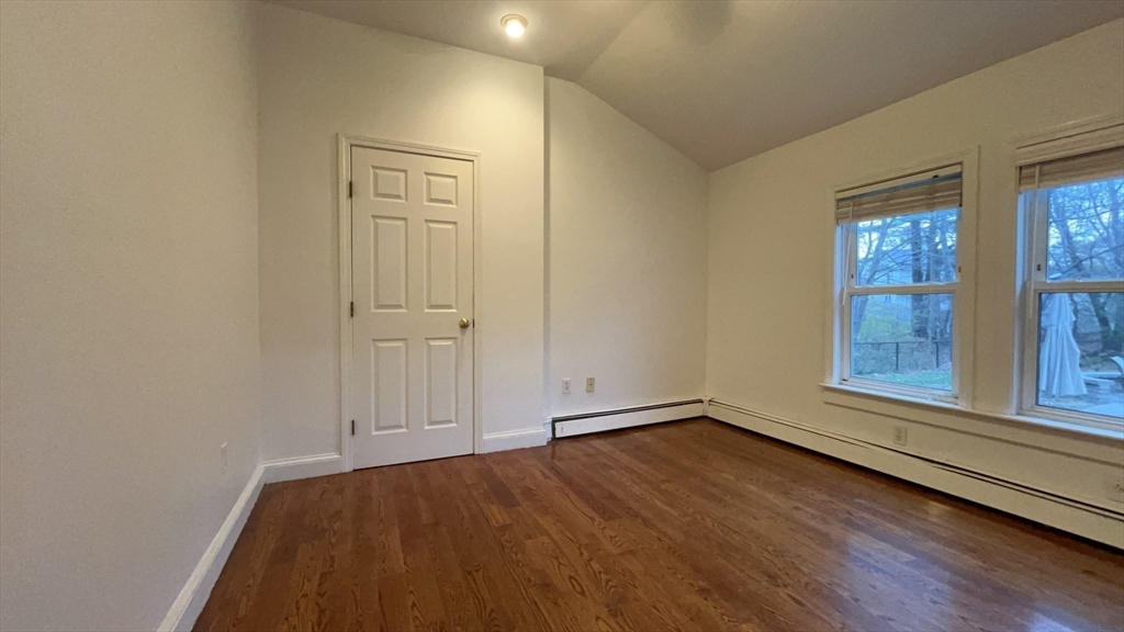 415 Pearl Street Stoughton, MA 02072 - Photo 12 of 24 an empty room with wooden floor and windows