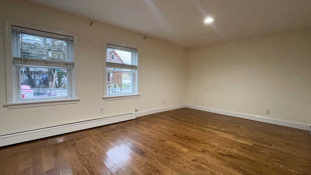415 Pearl Street Stoughton, MA 02072 - Photo 13 of 24 a view of a big room with wooden floor and windows
