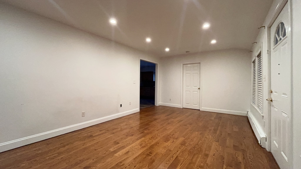 415 Pearl Street Stoughton, MA 02072 - Photo 14 of 24 an empty room with wooden floor and windows