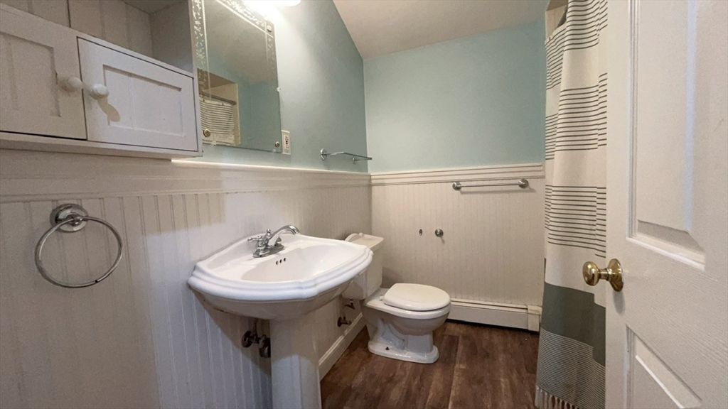 415 Pearl Street Stoughton, MA 02072 - Photo 17 of 24 a bathroom with a toilet sink and mirror