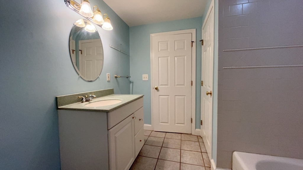415 Pearl Street Stoughton, MA 02072 - Photo 18 of 24 a bathroom with a sink and a mirror