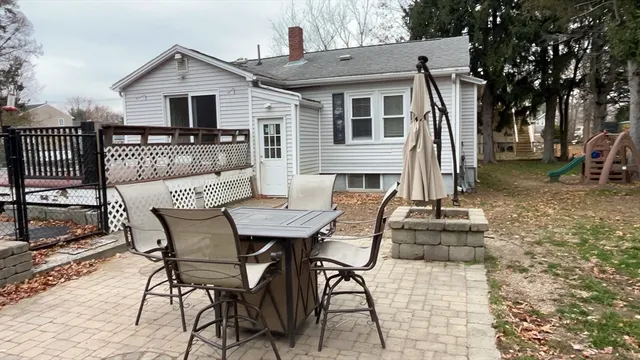 a view of a house with backyard and sitting area