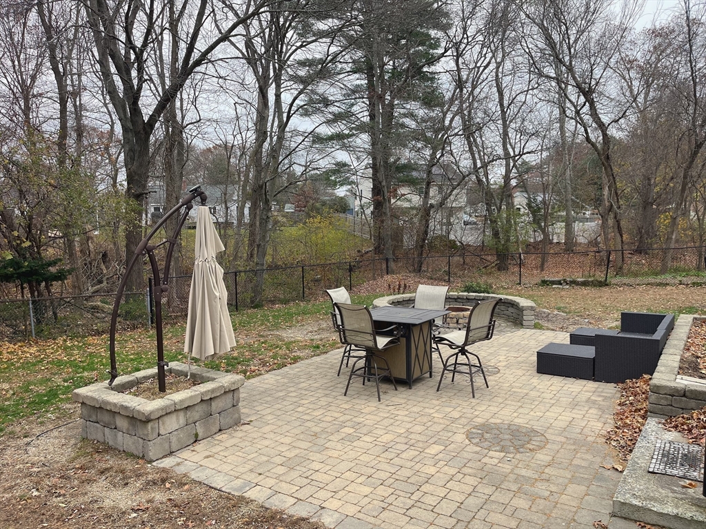 415 Pearl Street Stoughton, MA 02072 - Photo 23 of 24 a view of backyard with table and chairs couches with wooden fence and plants