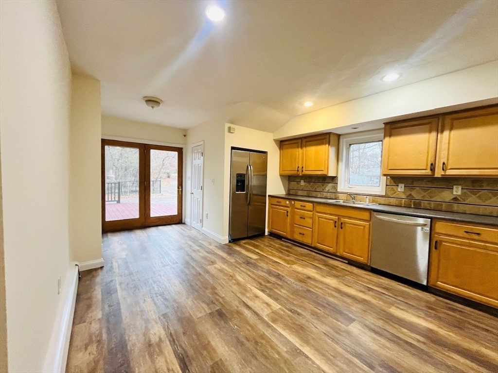415 Pearl Street Stoughton, MA 02072 - Photo 9 of 24 a view of a kitchen with a sink and dishwasher a refrigerator with wooden floor