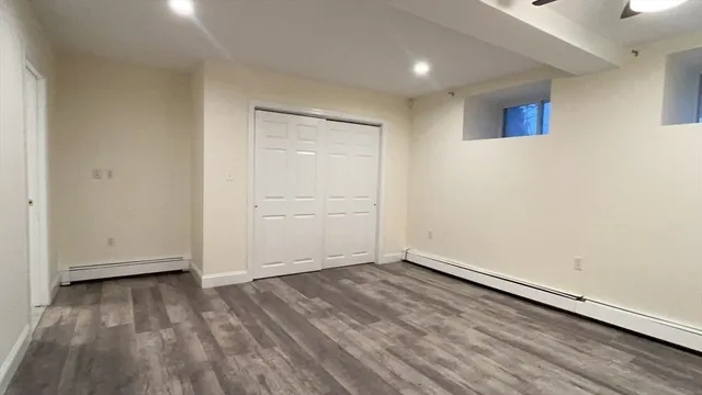 a view of empty room with wooden floor