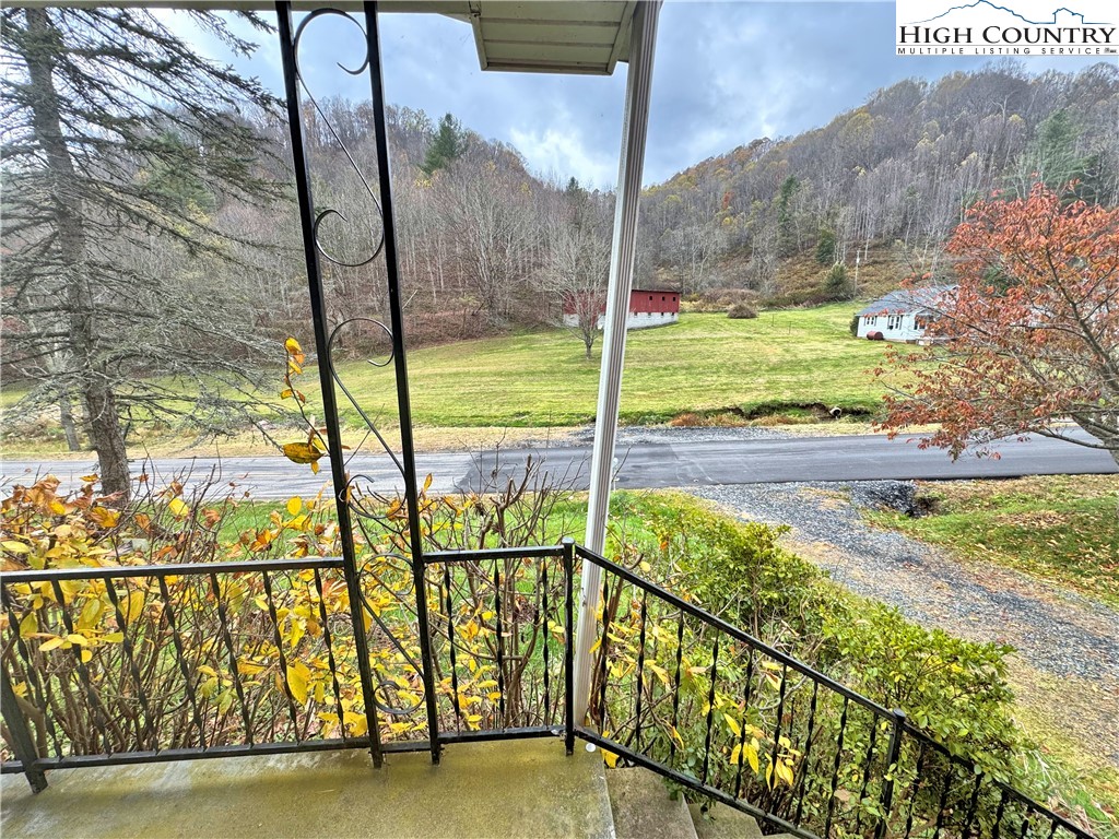2510 Rich Hill Road Creston, NC 28615 - Photo 19 of 29 a view of a balcony with floor to ceiling windows and wooden fence
