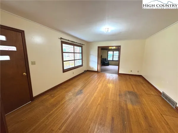 wooden floor in an empty room with a window