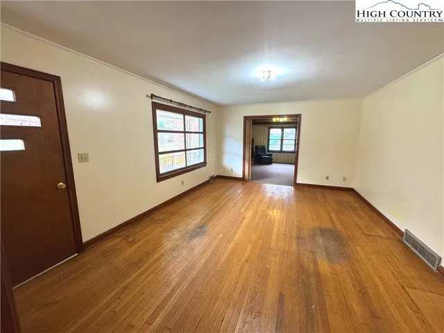 wooden floor in an empty room with a window