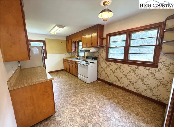 a kitchen with a stove a refrigerator and a sink