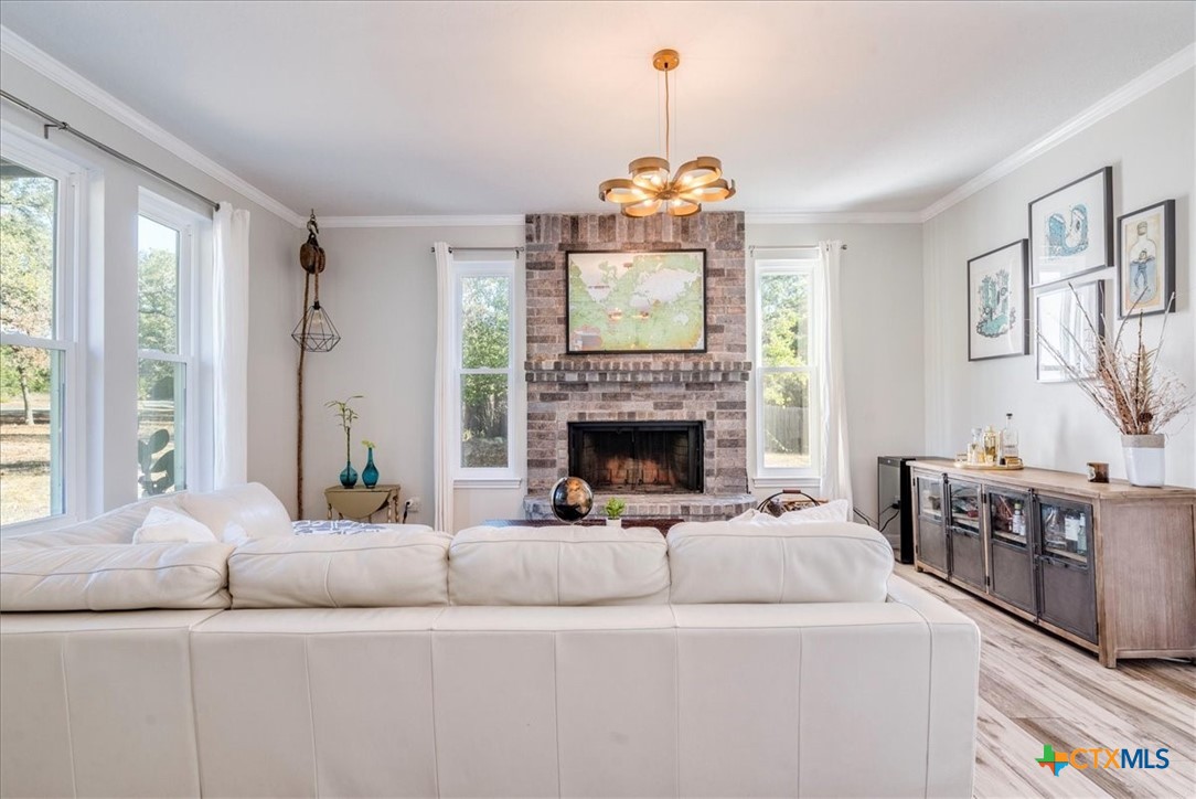 171 Pin Oak Crossing Elgin, TX 78621 - Photo 6 of 38 a living room with furniture and a fireplace