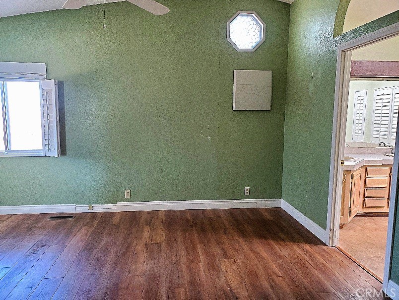 12550 Main Street, Unit 31 Hesperia, CA 92345 - Photo 26 of 50 an empty room with wooden floor and windows