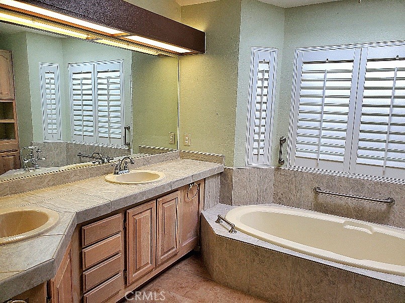 12550 Main Street, Unit 31 Hesperia, CA 92345 - Photo 30 of 50 a bathroom with a granite countertop sink and a bathtub