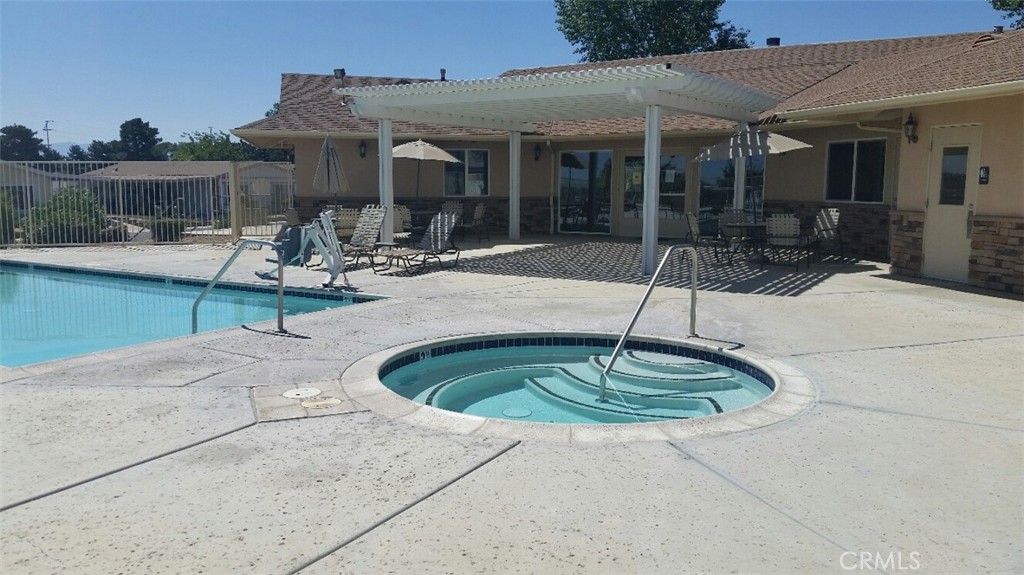 12550 Main Street, Unit 31 Hesperia, CA 92345 - Photo 49 of 50 a swimming pool with outdoor seating and yard