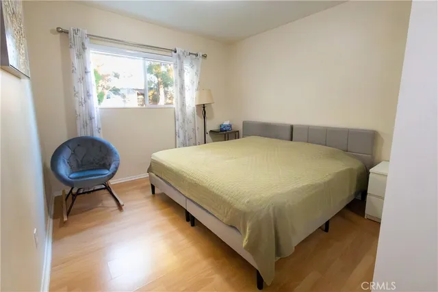 a bed sitting in a bedroom next to a window