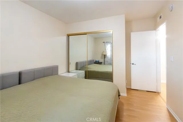 a bedroom with a bed and a mirror